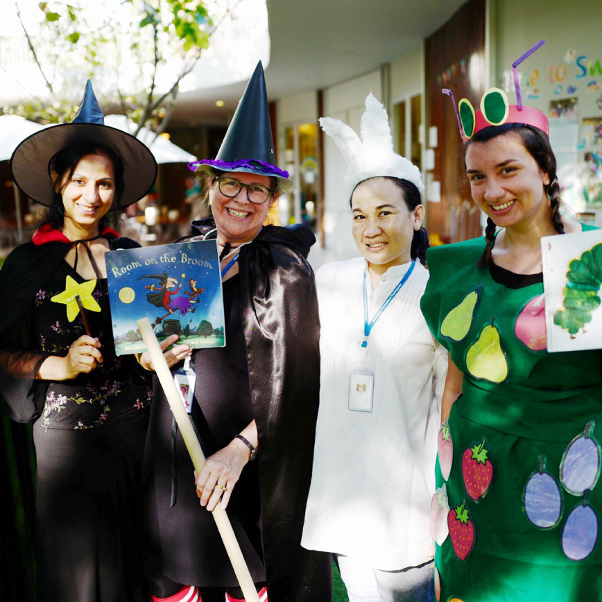 Kensington kindergarten teacher and staff playing and taking a group photo in Halloween's Day